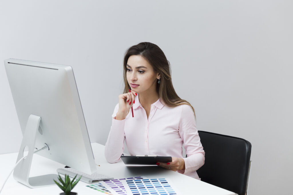 front view working woman looking computer holding tablet